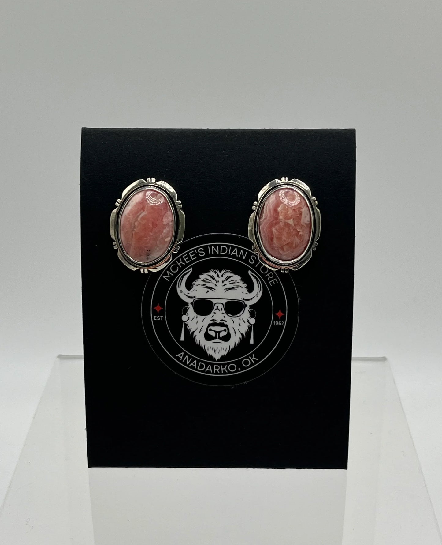Pink stone oval earrings in silver settings, displayed on black McKee's Indian Store card from Anadarko, OK
