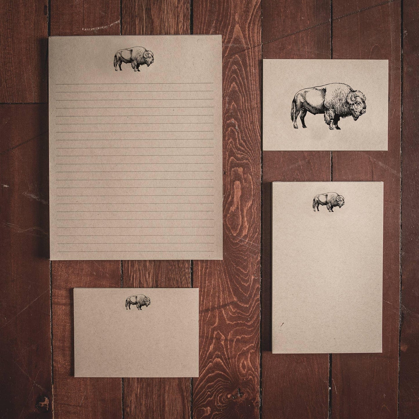 Buffalo-themed stationery set with lined paper, cards, and envelopes on rustic wood