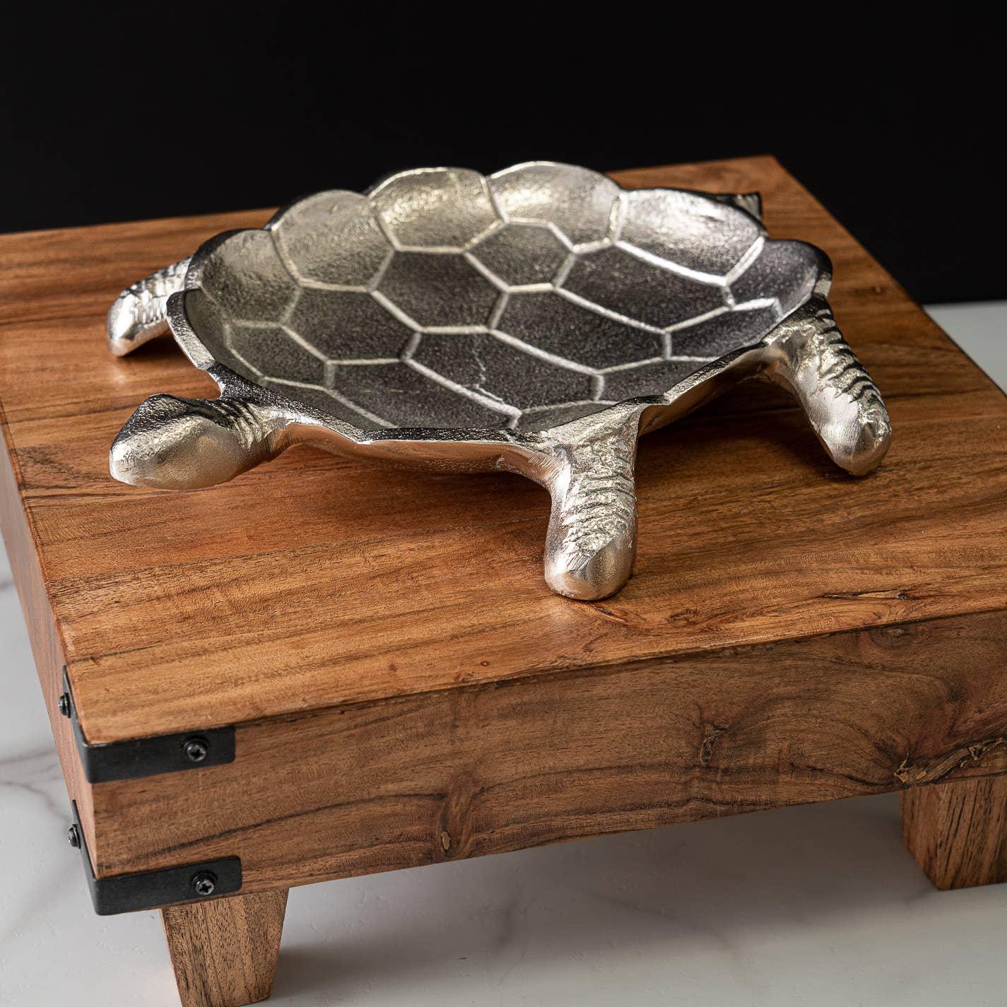 Silver turtle-shaped dish with detailed shell, displayed on rustic wood table for Native art decor