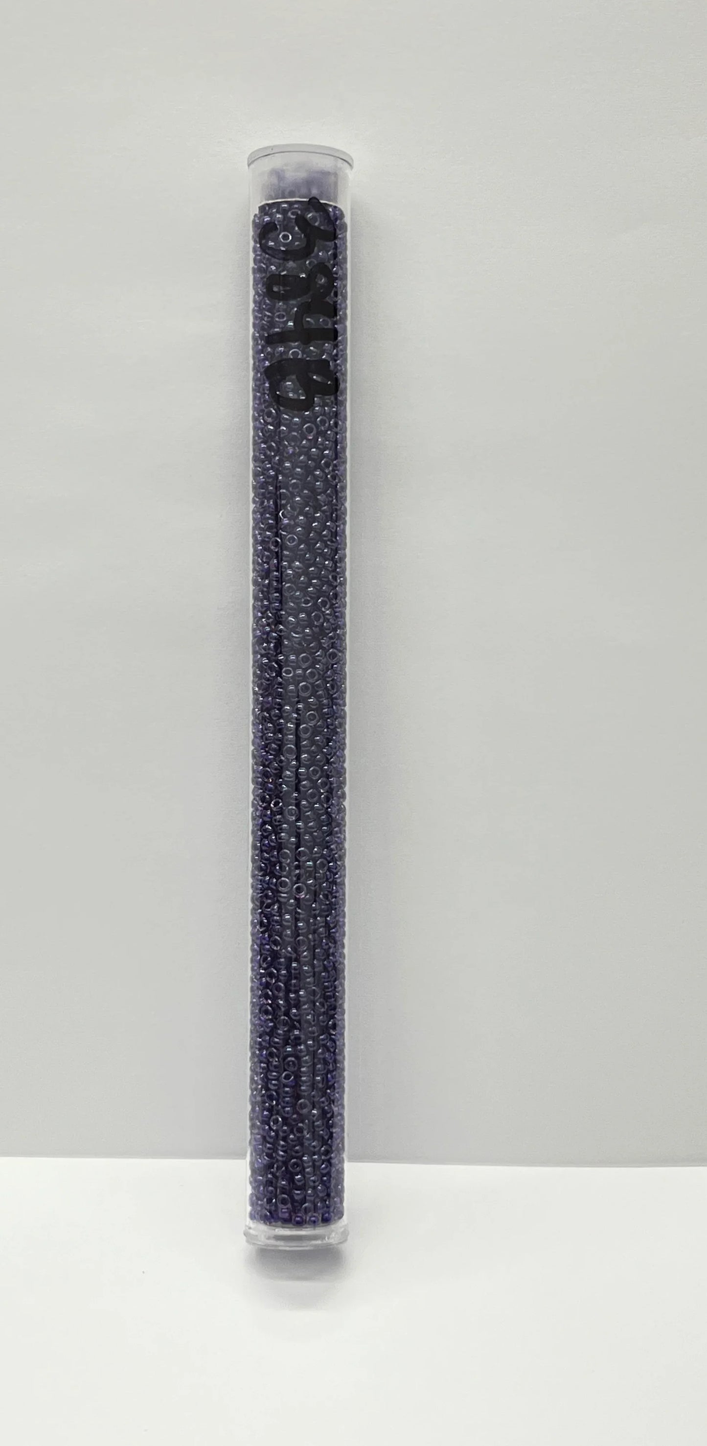 Purple seed beads in clear tube for Native American crafts and traditional clothing projects