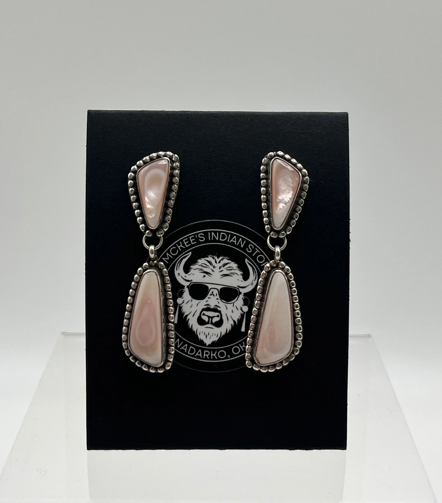 Native American style drop earrings with pink mother-of-pearl and silver beaded frames, displayed on black card.