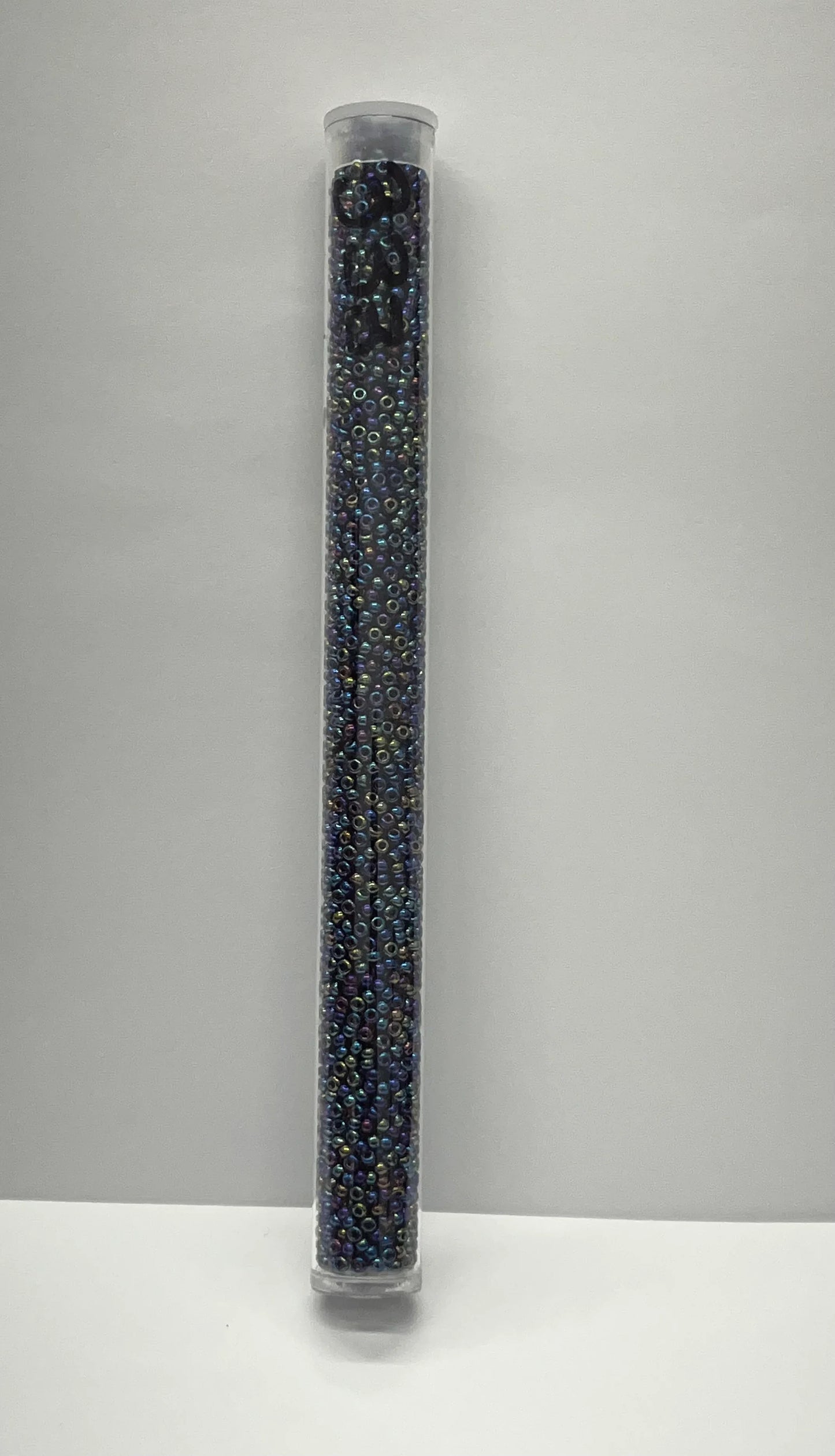 Iridescent blue seed beads in clear tube for Native American crafts and traditional clothing