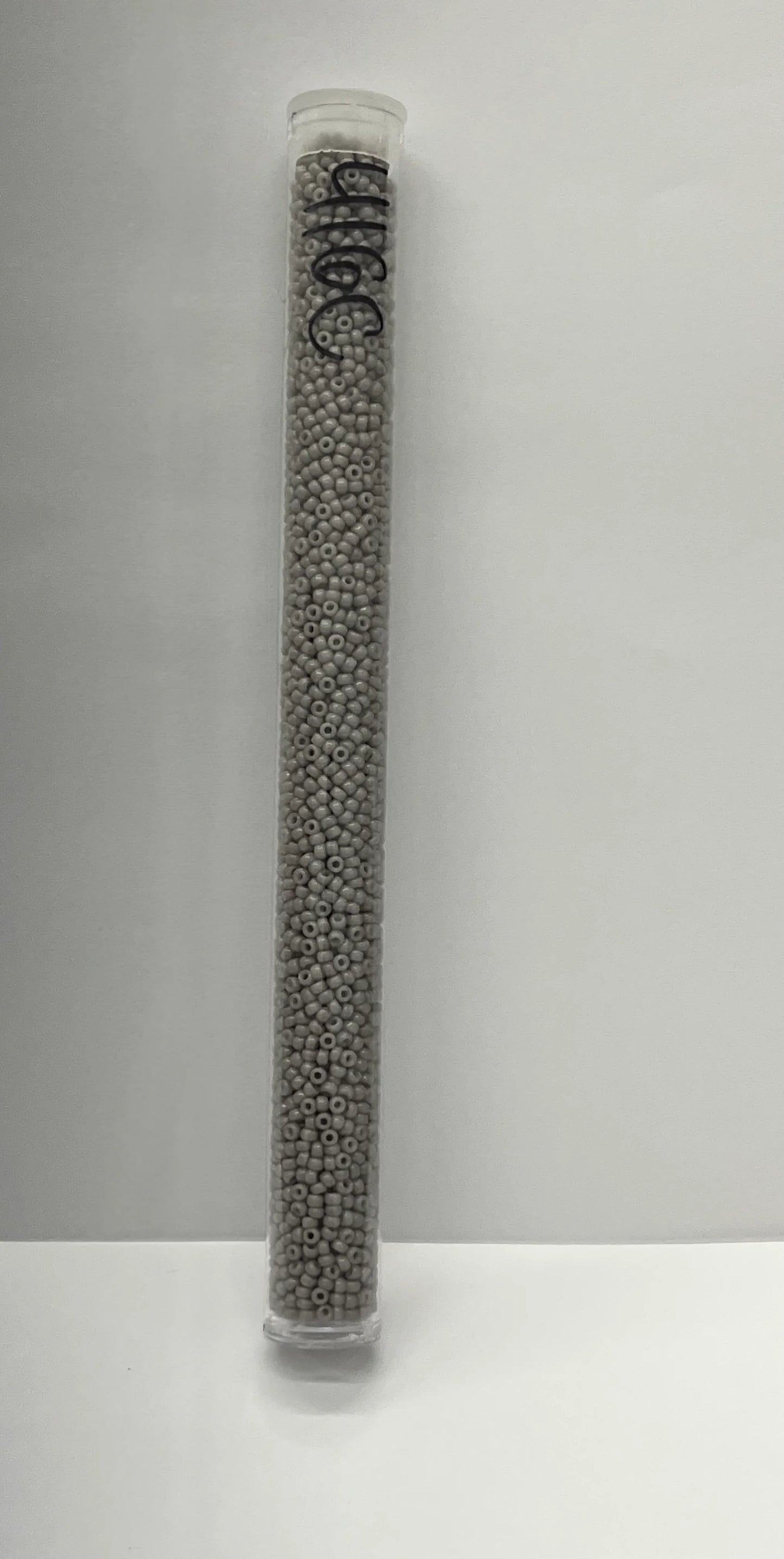 Gray seed beads in clear tube for Native American crafts and traditional clothing projects