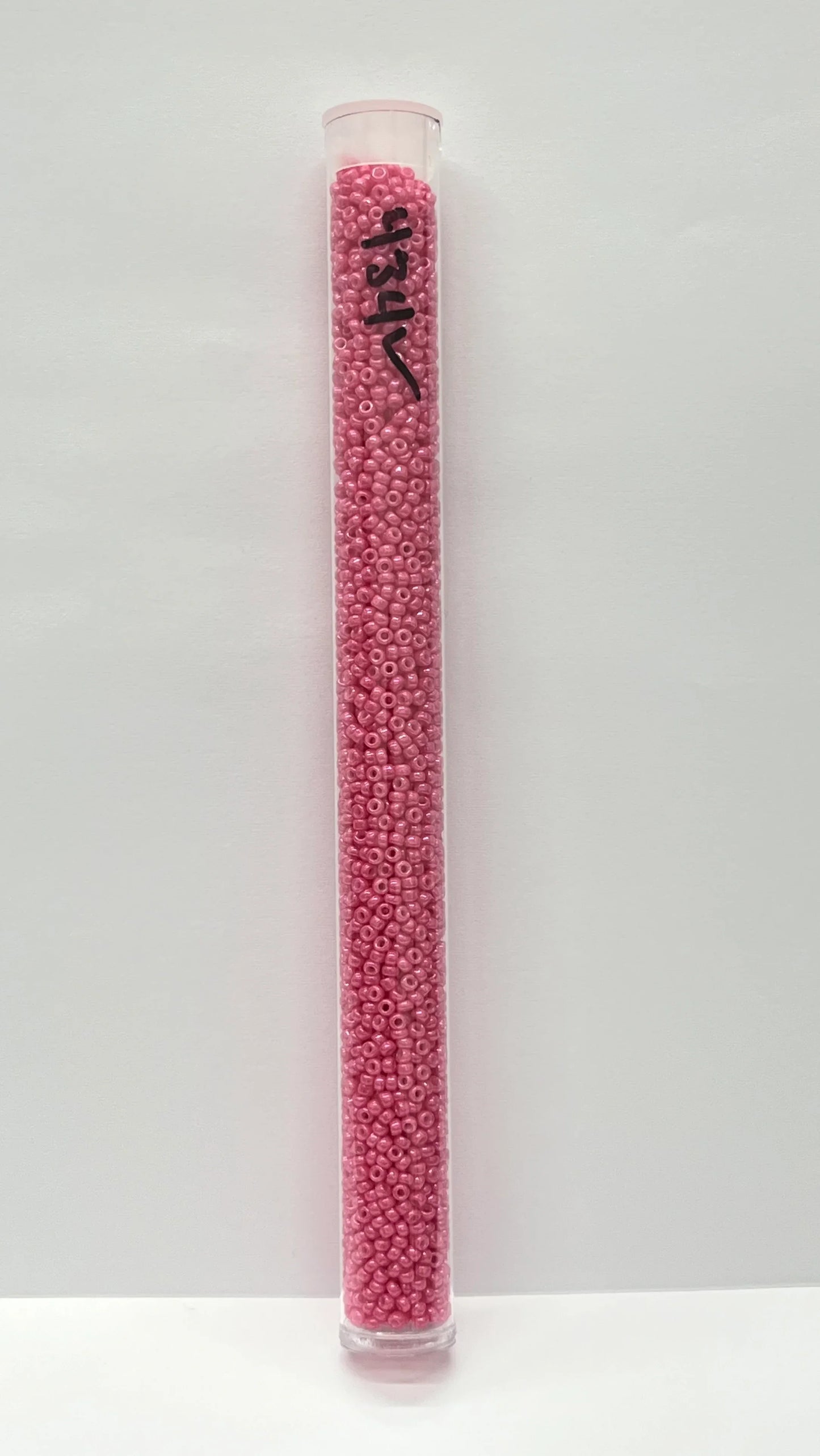 Pink seed beads in clear tube for Native American crafts and traditional clothing projects