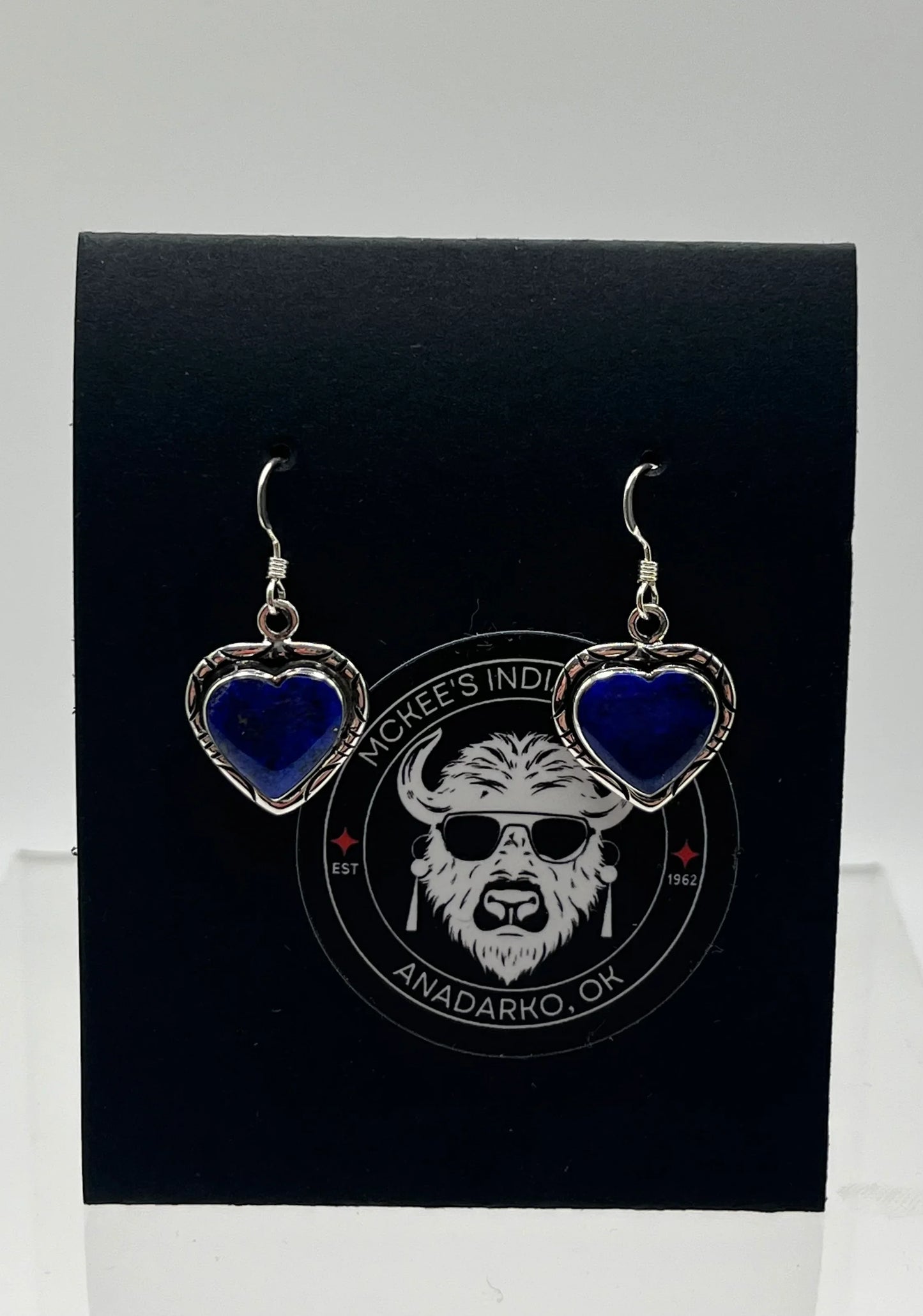 Heart-shaped blue stone earrings with silver frames, displayed on black card featuring Anadarko, OK logo
