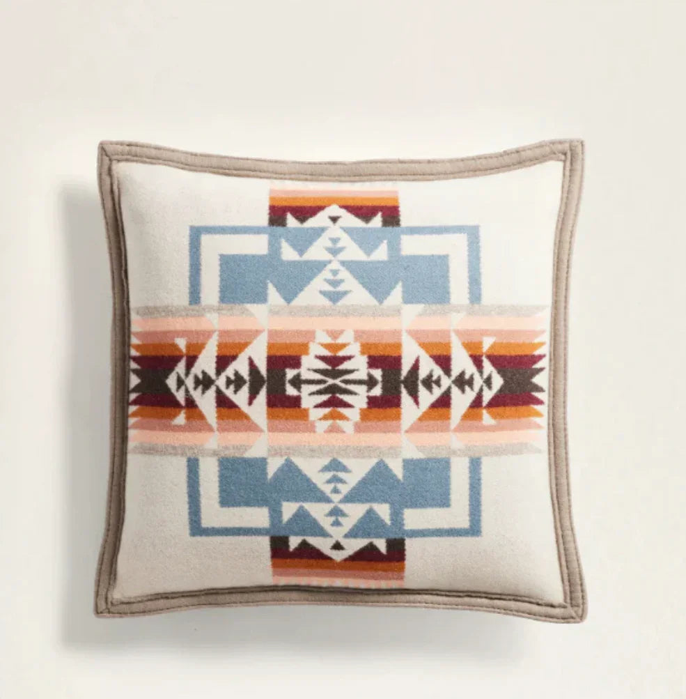 Native American patterned throw pillow with geometric designs in earth tones and blue