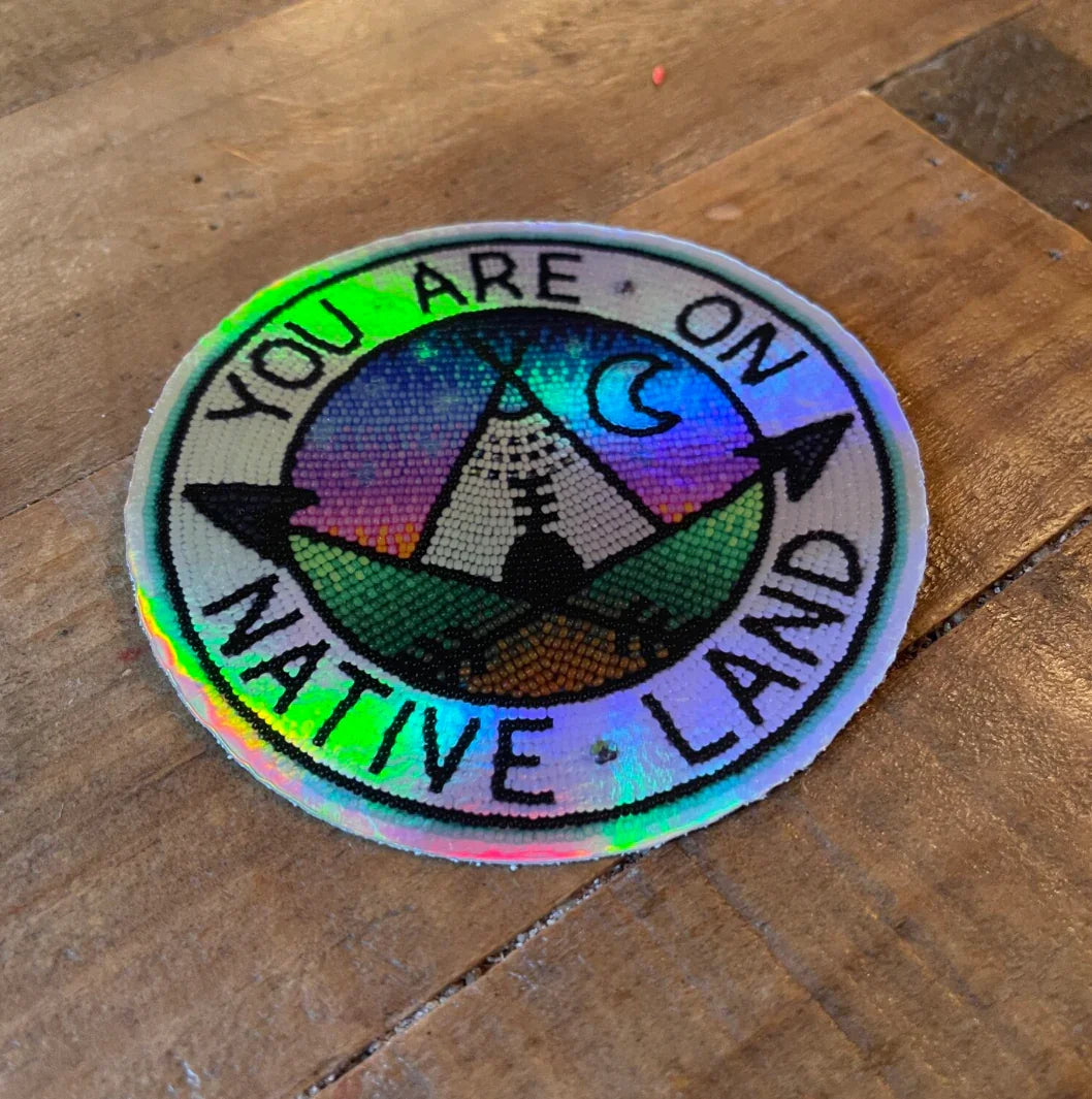 Holographic beaded patch reading 'You Are On Native Land' with teepee, moon, and arrow design