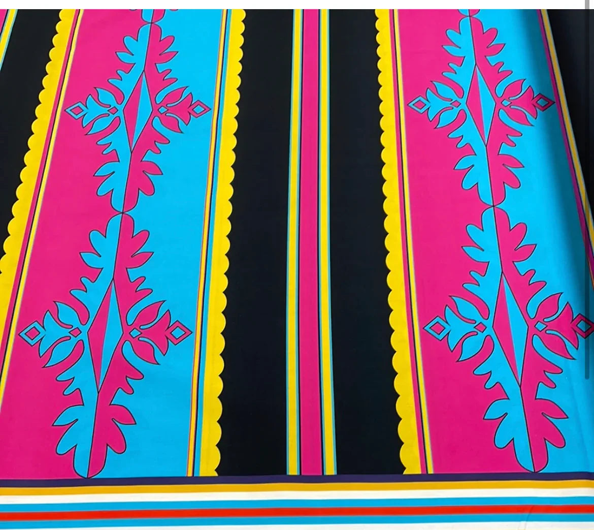 Vibrant Native American print fabric with bold pink, blue, and yellow geometric patterns for traditional clothing and crafts