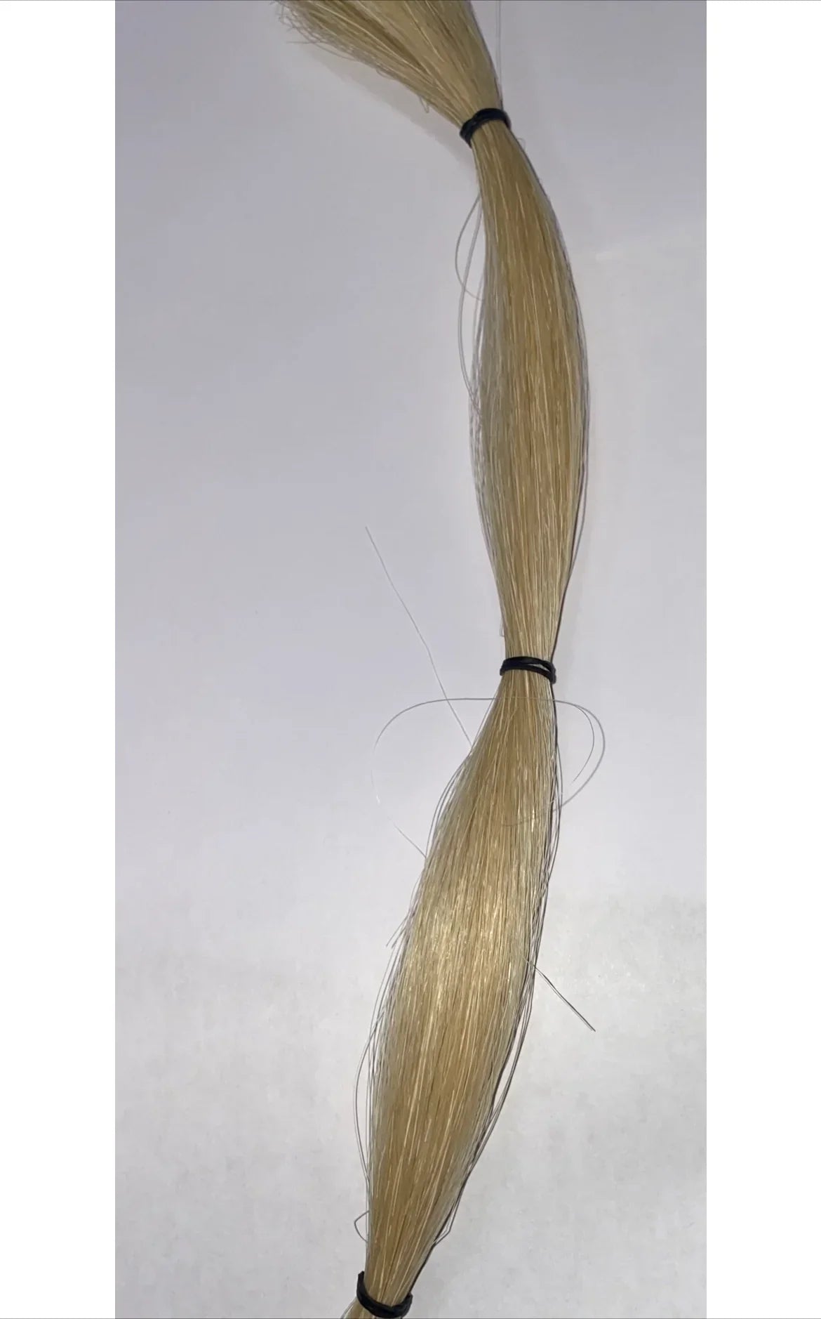Blonde synthetic hair bundle for Native American crafts and traditional regalia, secured with black bands