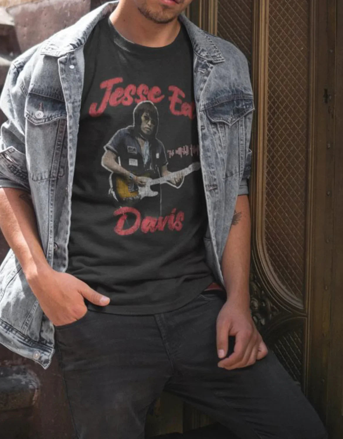 Man wearing Jesse Ed Davis graphic tee with denim jacket, showcasing Native artist music apparel