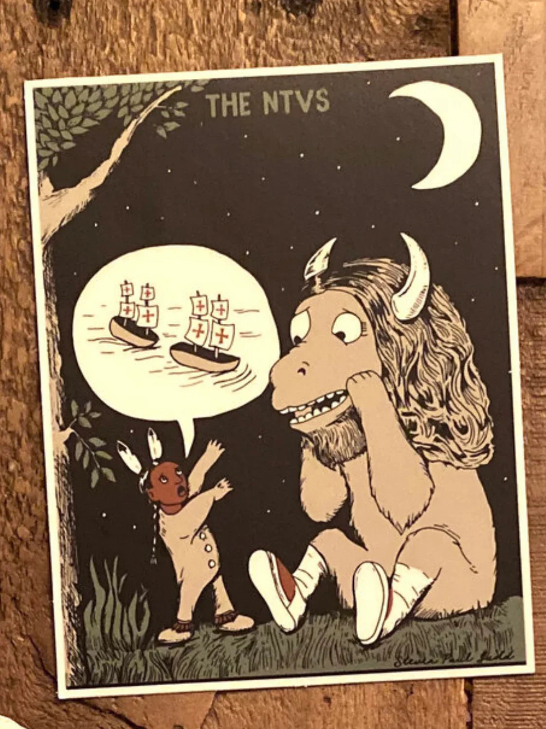 Native art print featuring a child and horned figure under moon, ships in speech bubble, 'THE NTVS'