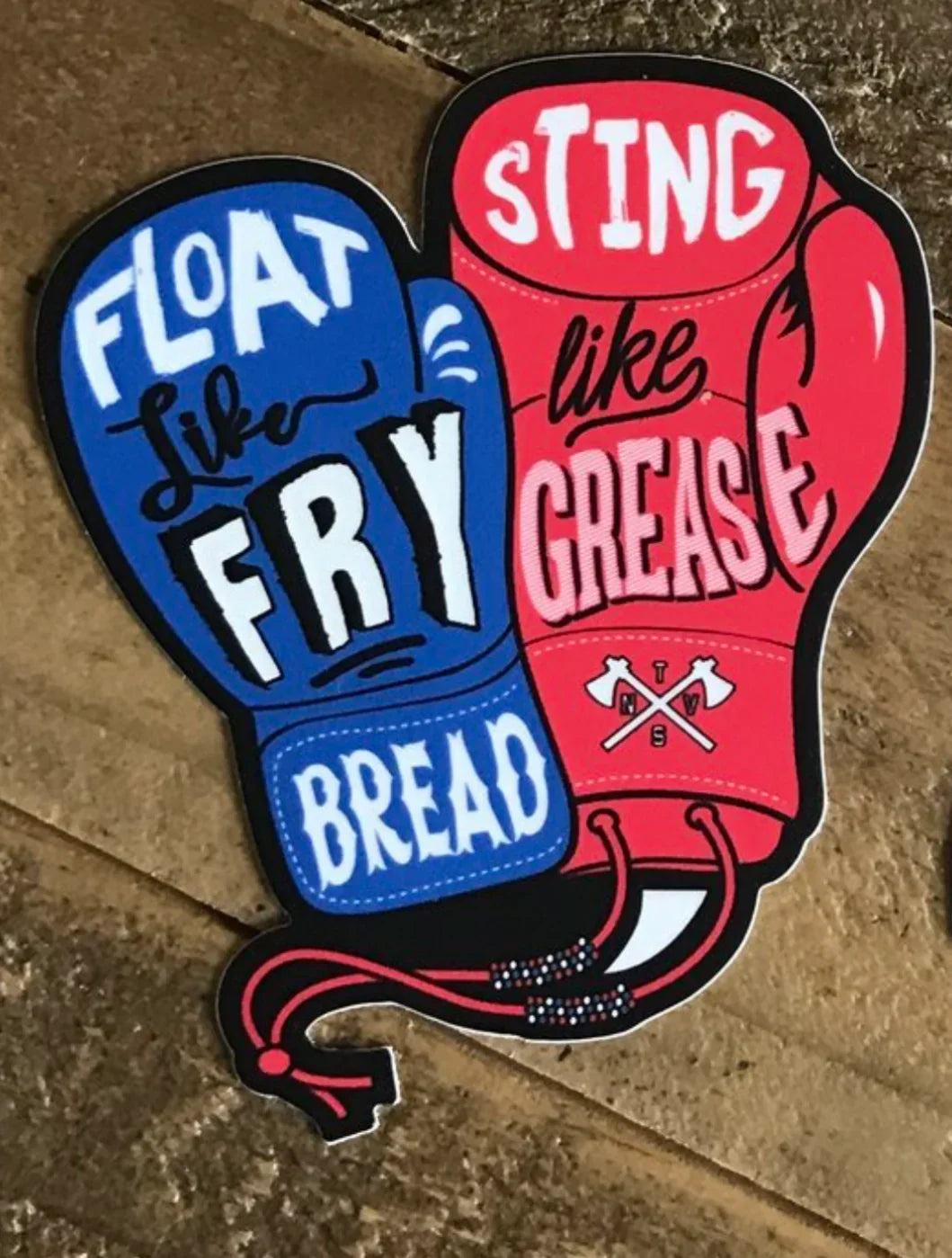 Funny boxing glove sticker with 'Float like fry bread, sting like grease' text, Native art style
