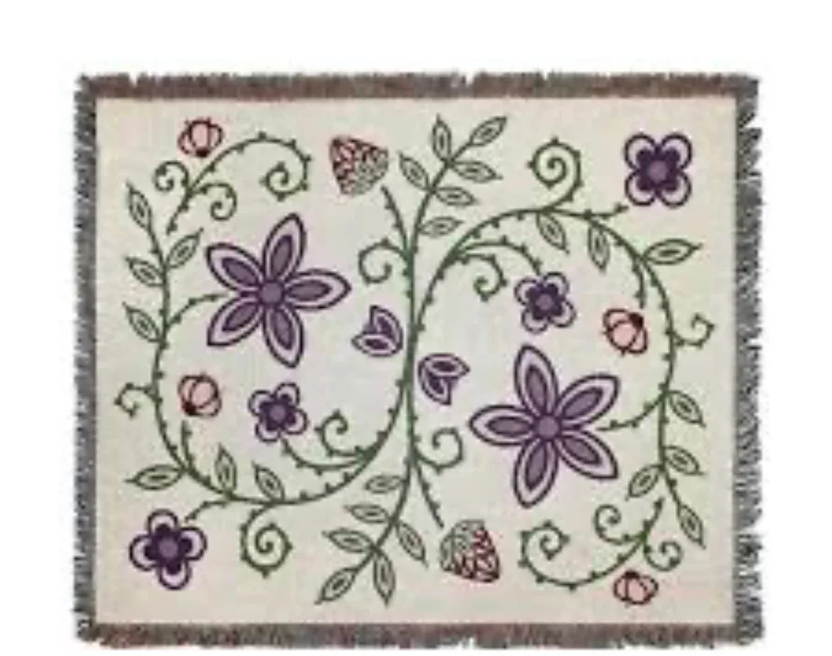Floral patterned woven blanket with purple flowers, green vines, and fringe edges for Native art decor