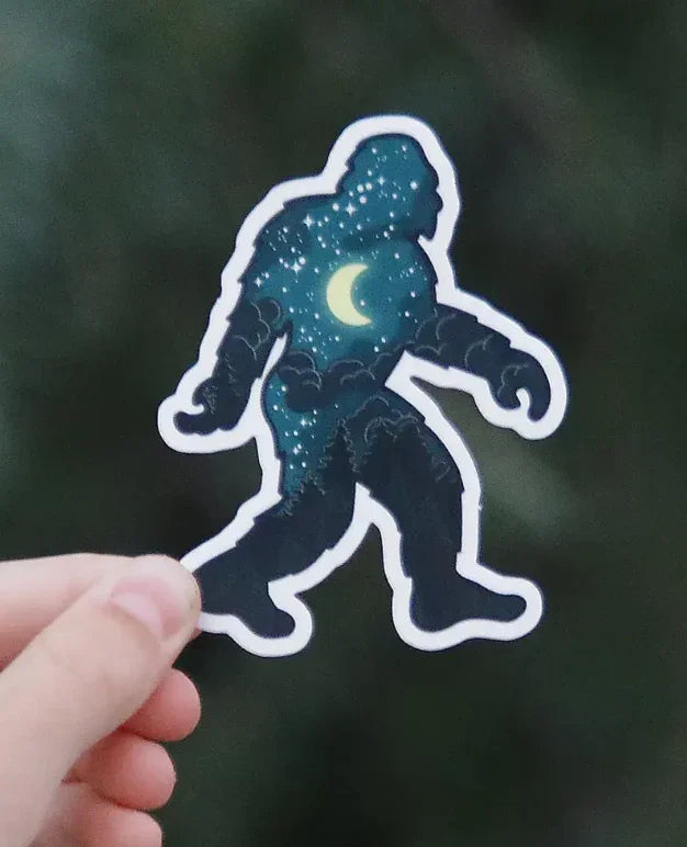 Sticker of Bigfoot silhouette with starry night sky and crescent moon design