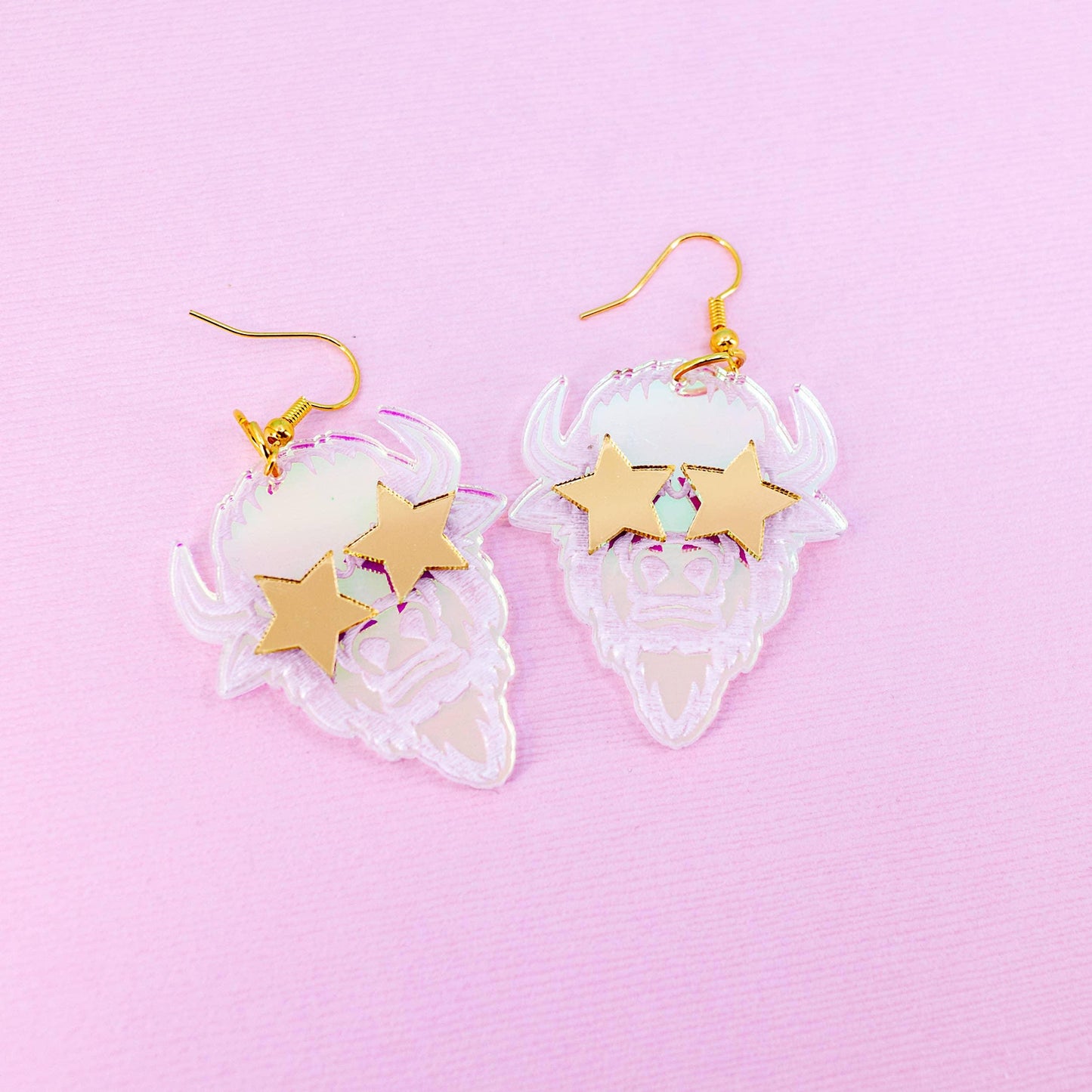 Clear buffalo head earrings with gold stars, Native art inspired, pink background
