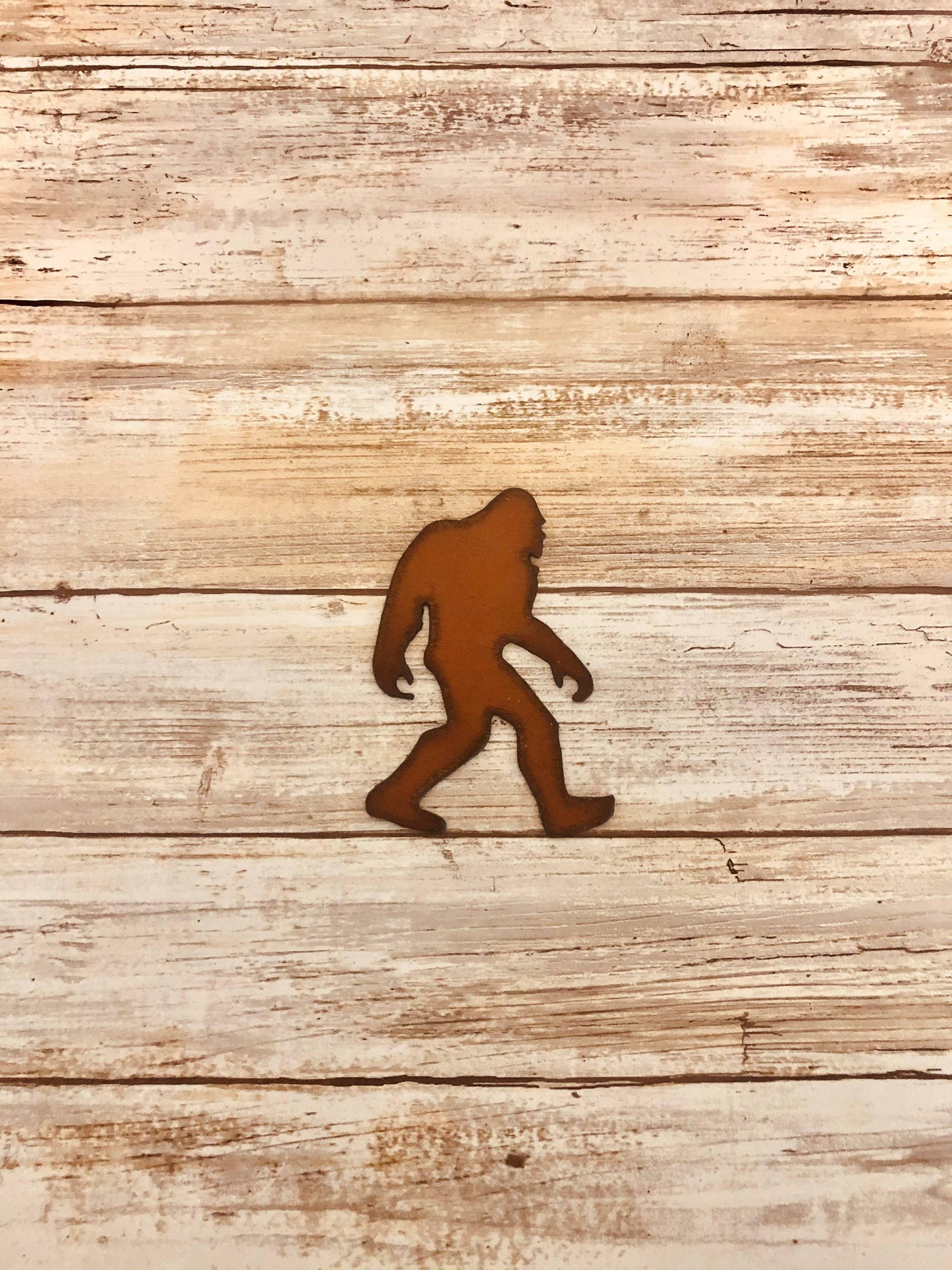 Rustic metal Bigfoot cutout for Native art crafts on weathered wood