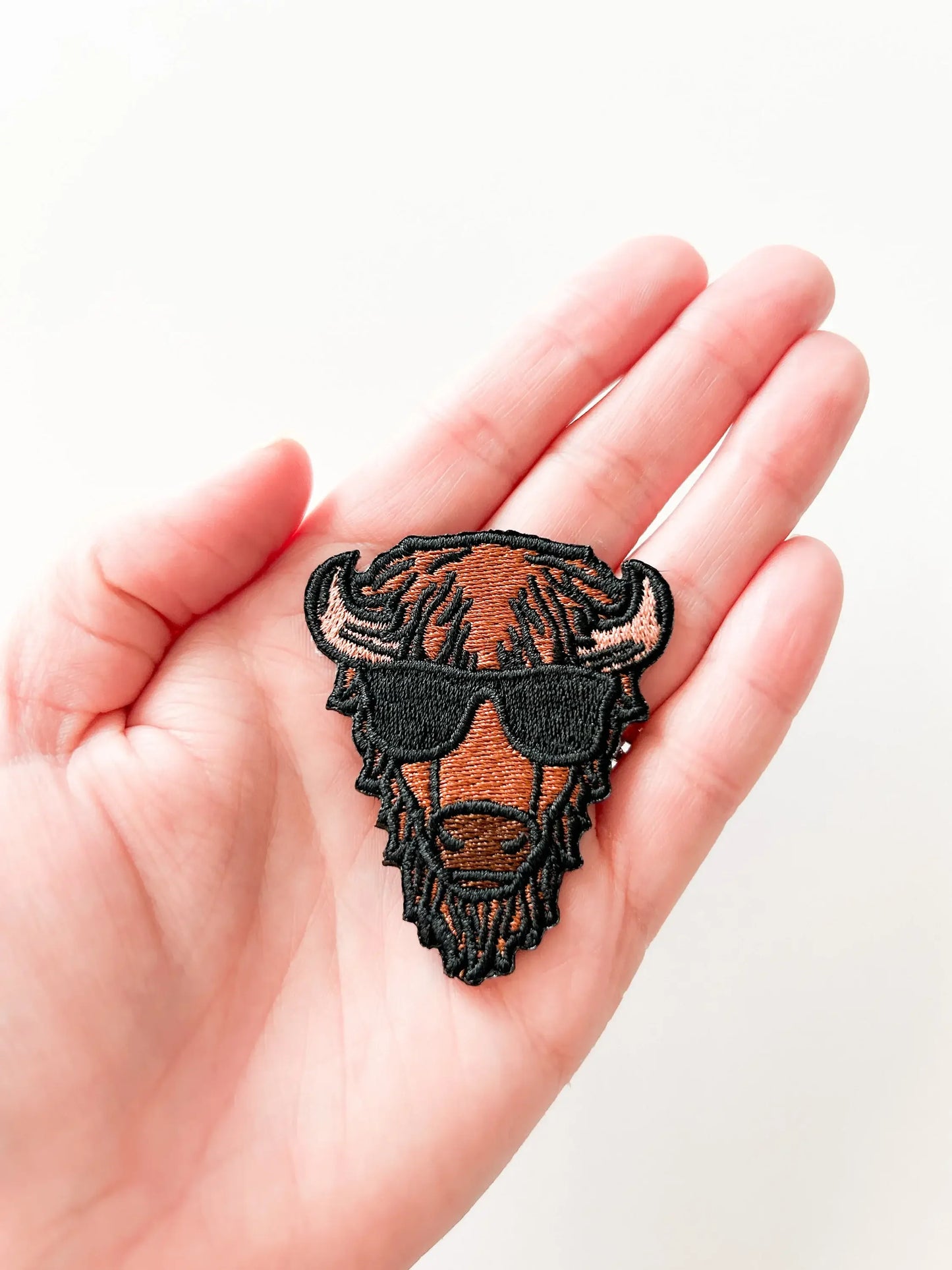 Embroidered bison head patch with sunglasses, perfect for Native art crafts and traditional clothing projects.