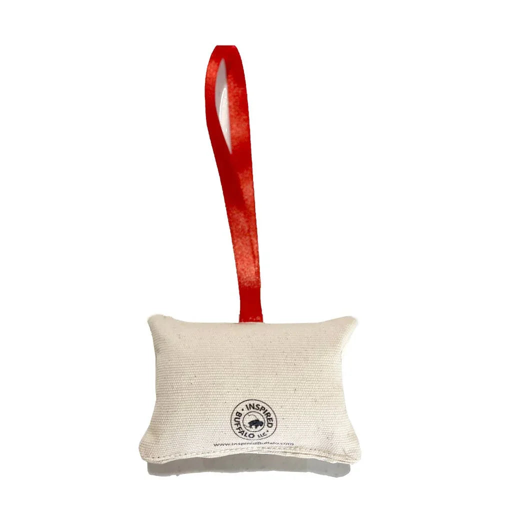 Natural canvas sachet with red ribbon, featuring Inspired Buffalo LLC logo, ideal for Native art supplies and crafts.