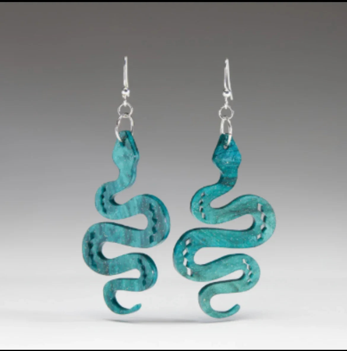 Turquoise snake-shaped earrings with intricate cutouts, perfect for Native art and craft enthusiasts.