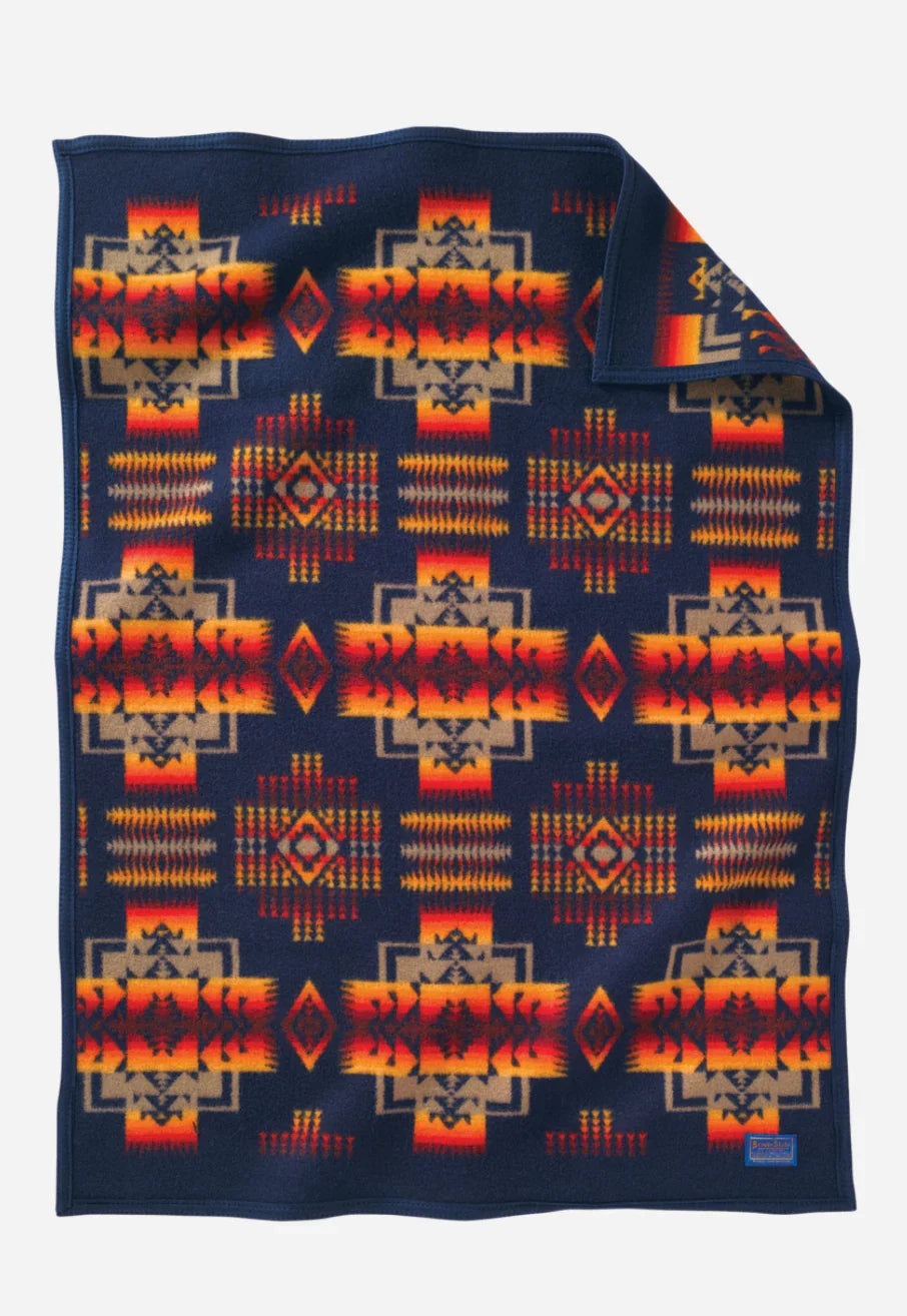 Native American patterned blanket with geometric designs in orange, red, and navy blue