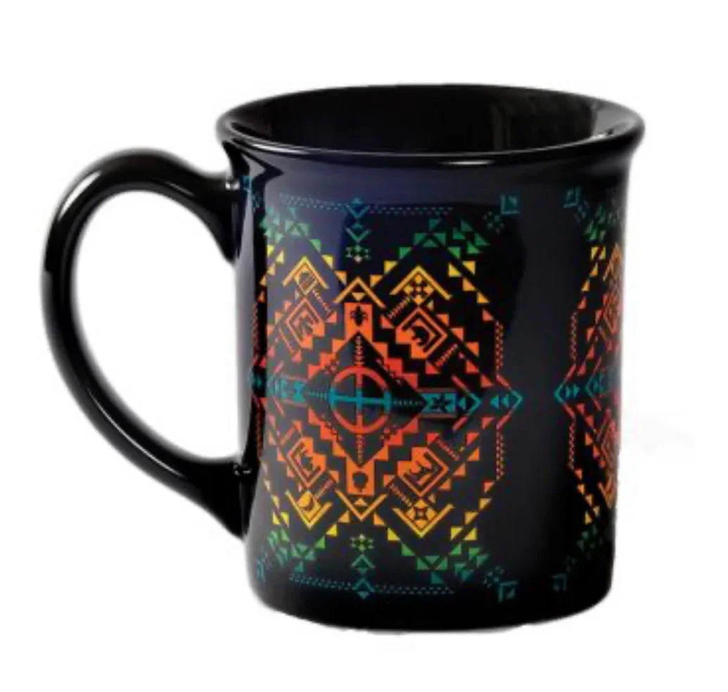 Black mug with vibrant Native American geometric patterns in orange, green, and teal