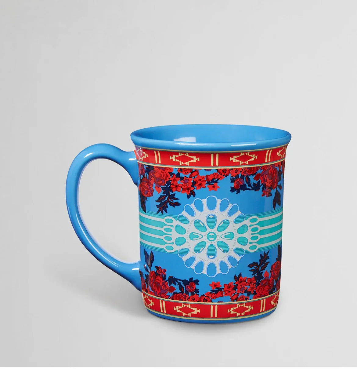 Blue ceramic mug with red floral and Native-inspired geometric patterns, ideal for traditional art enthusiasts.