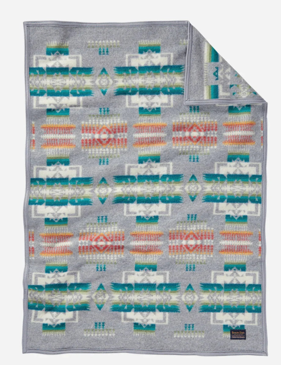Gray blanket with Native American geometric patterns in teal, orange, and white for traditional crafts