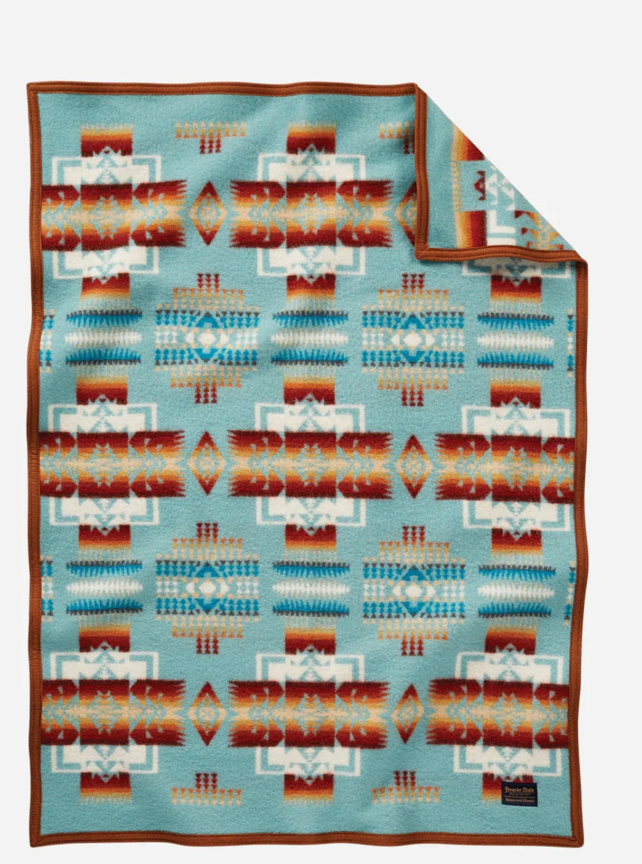 Native American patterned blanket with turquoise, red, and white geometric designs