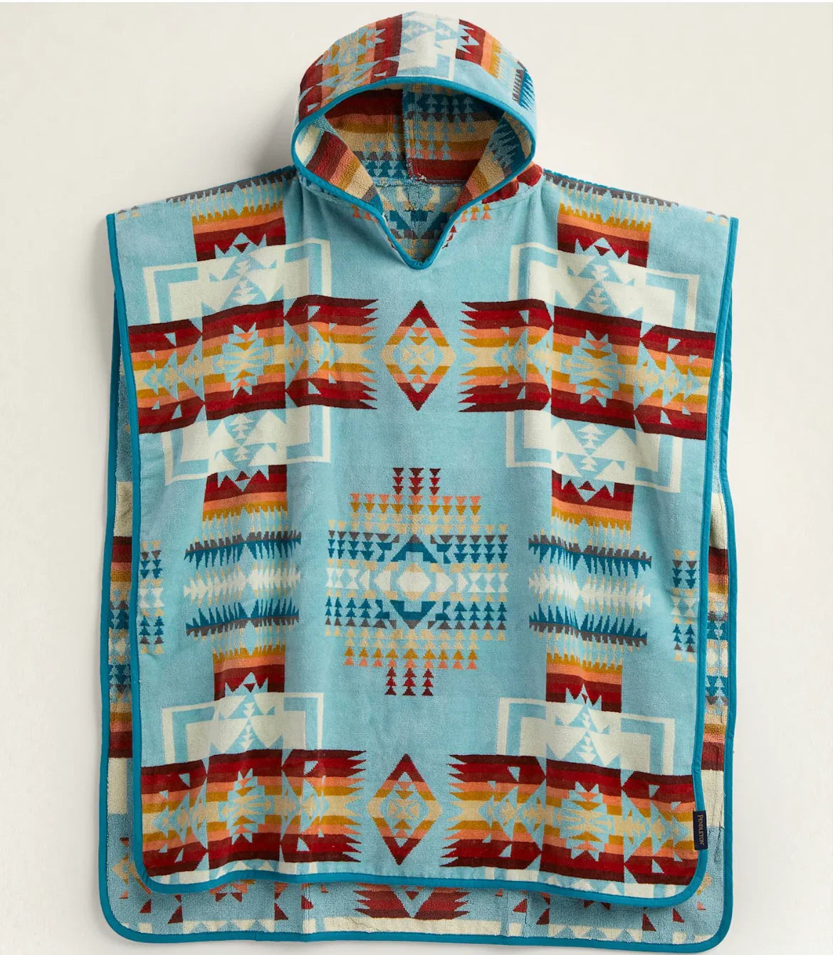 Native-inspired hooded blanket with geometric patterns in blue, red, and orange tones