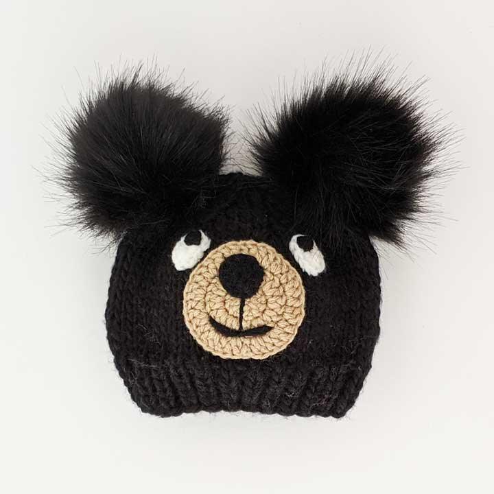 Black knit bear hat with fluffy ears and crocheted face, perfect for Native art crafts and traditional wear.