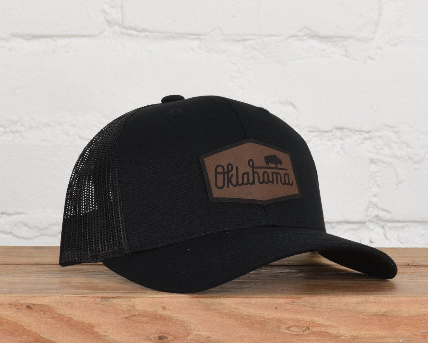 Black trucker hat with Oklahoma bison patch, perfect for Native art and craft enthusiasts in Anadarko.