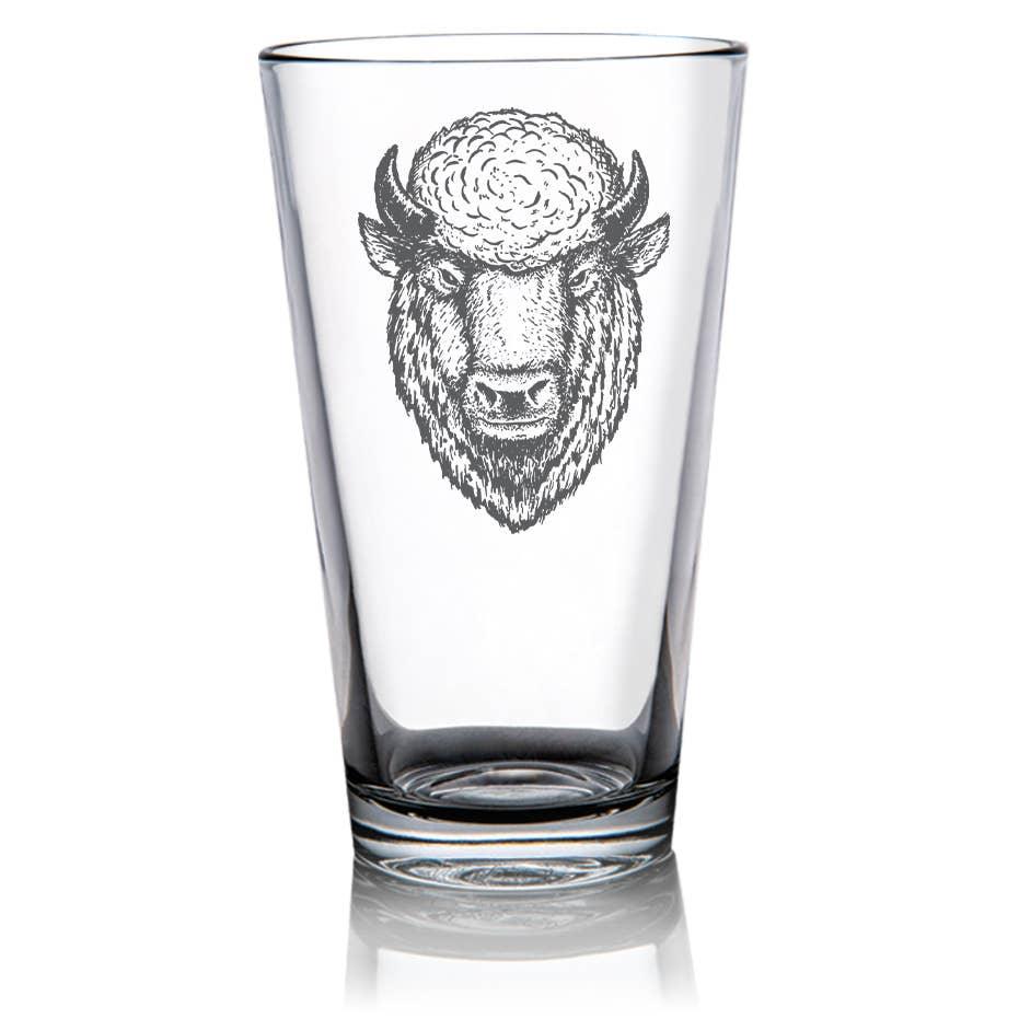 Clear pint glass with etched bison head design, Native American art inspired