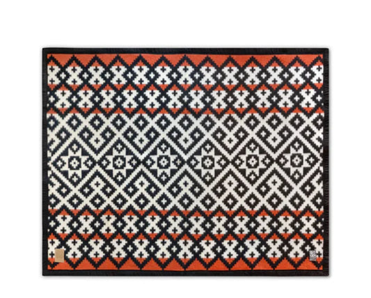 Native American patterned rug with geometric diamond designs in black, white, and orange