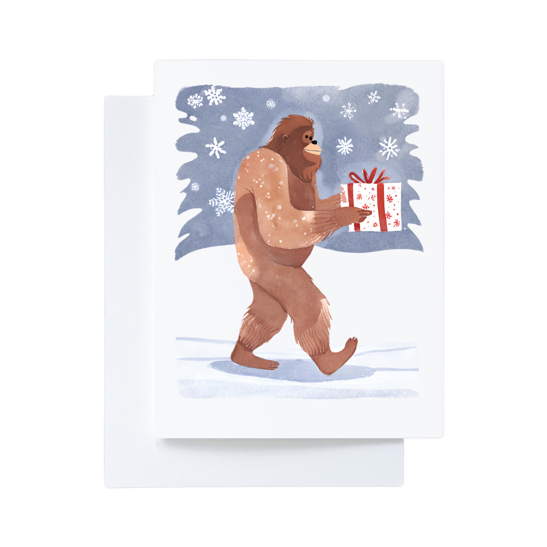 Bigfoot Carrying a Christmas Present in the Snow Card : Brown Kraft Paper